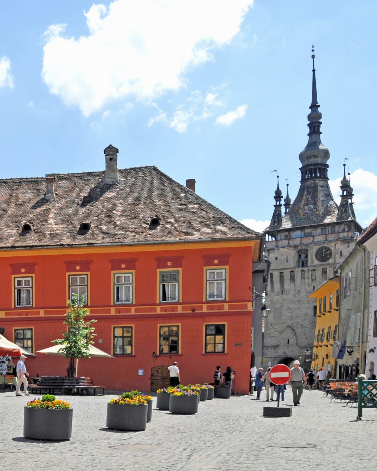 Pastel-painted Saxon houses around Piața Cetății with the Clock Tower rising behind